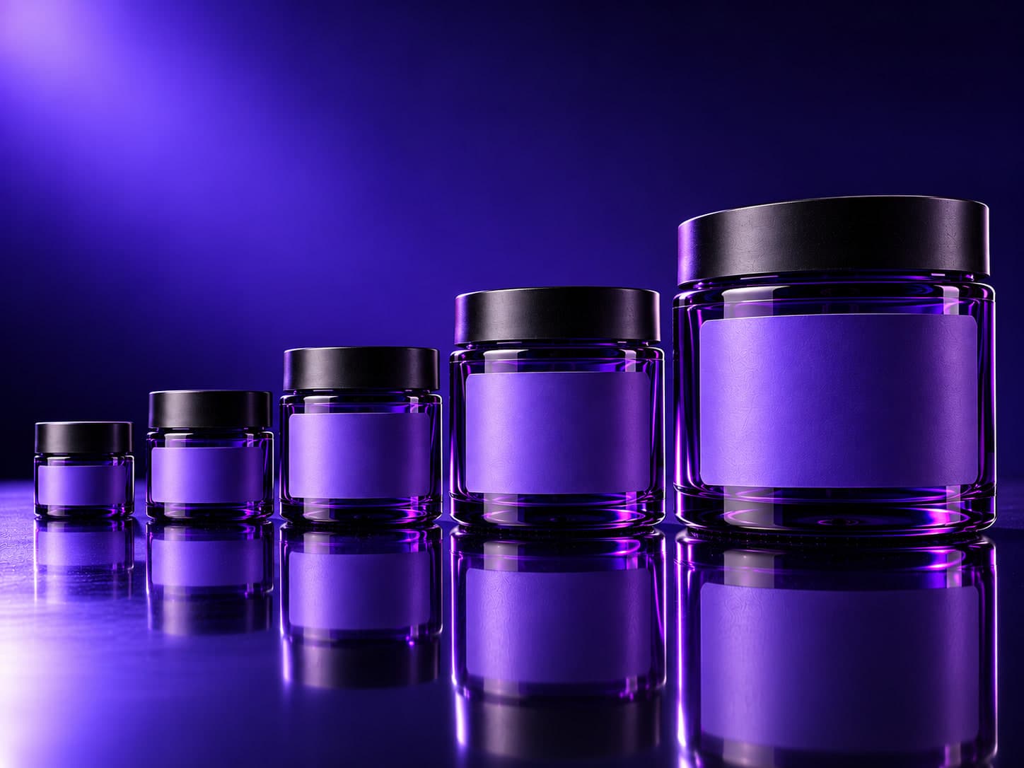 Five purple glass jars in ascending sizes, each with a blank violet label
